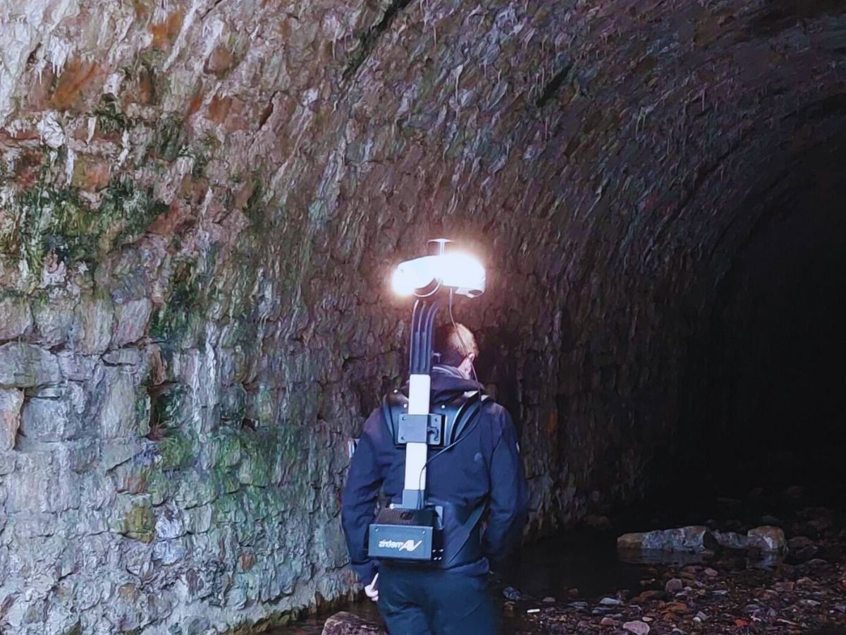 A man doing indoor mapping inside a tunnel